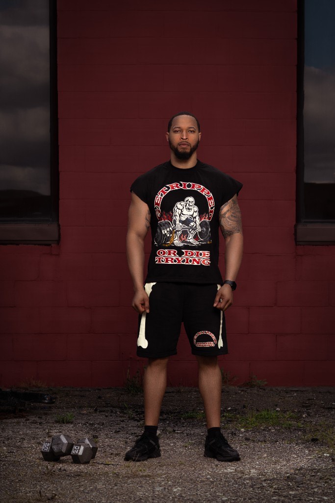 Full GRODT fit with sleeveless t-shirt and bone print shorts, dumbbells on the ground