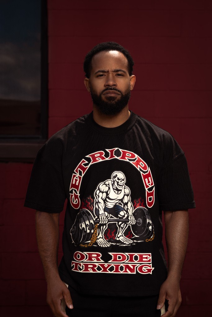 GRODT Oversized T-Shirt front view against a red brick wall