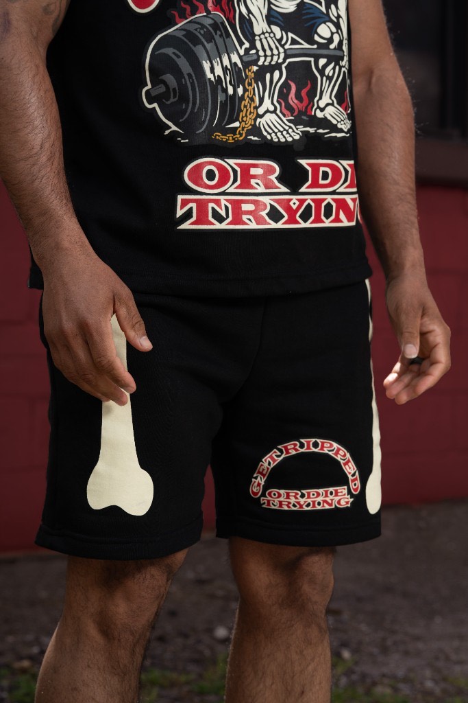 GRODT Shorts in black with bone print and arched logo
